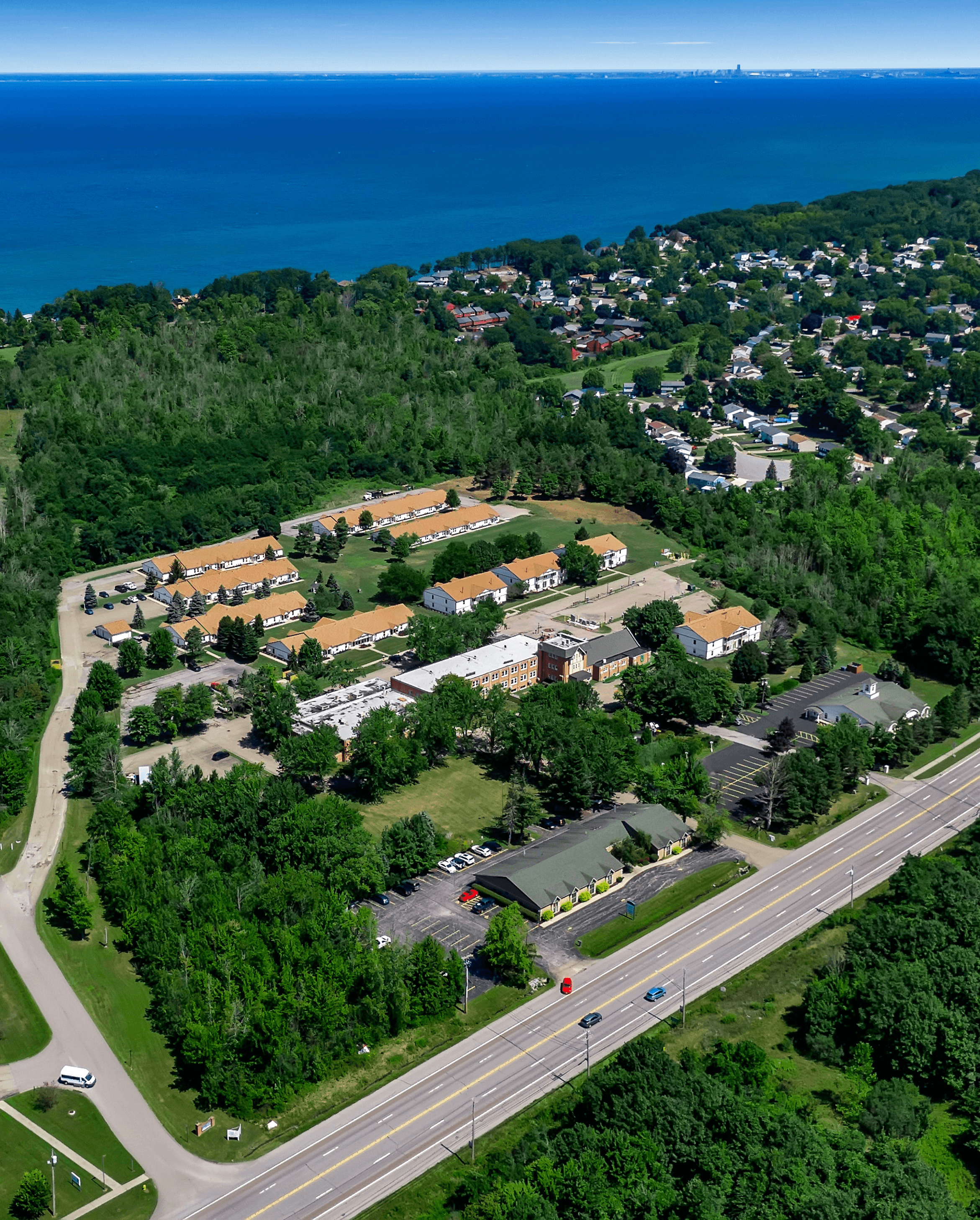 A bird's eye view of a residential area with a road running through it.